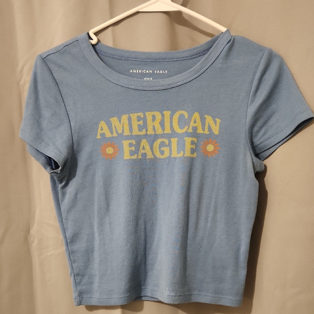 American Eagle Outfitters Light Blue Crop Tee with Yellow Daisy Logo